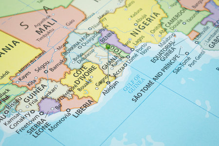 Close up to a Abidjan city with a green pin needle into Ivory Coast country political mapの写真素材