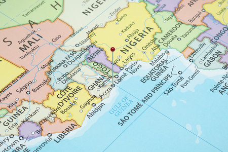 Close up to an Accra city with a red pin needle into Ghana country political mapの写真素材