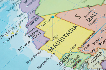 Close up to a Atar city with a light blue pin needle into Mauritania country political mapの写真素材
