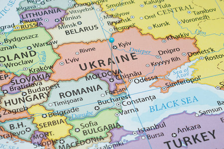 Close up to a Chisinau city with a light blue pin needle into Moldova country political mapの写真素材