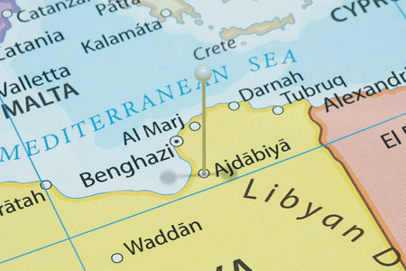 Close up to a Ajdabiya city with a white pin needle into Libya country political mapの写真素材