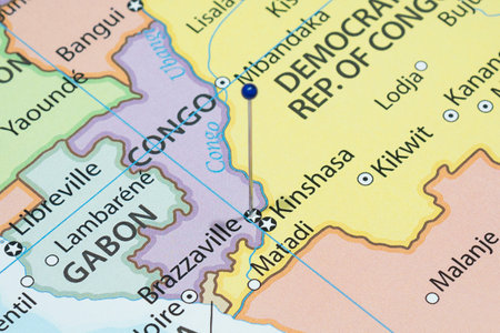 Close up to a Brazzaville city with a blue pin needle into Congo country political mapの写真素材