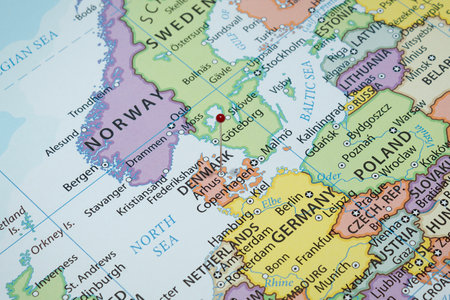 Close up to a Arhus city with a red pin needle into Denmark country political map