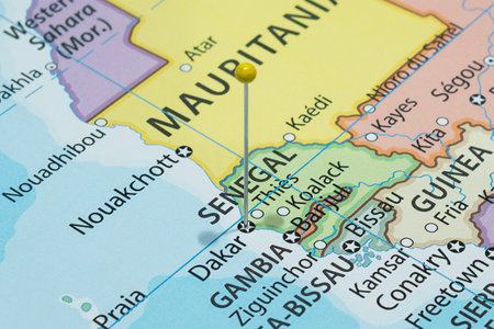 Close up to a Dakar city with a Yellow pin needle into Senegal country political mapの写真素材