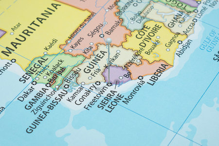 Close up to a Freetown city with a white pin needle into Sierra Leone country political mapの写真素材