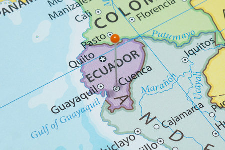 Close up to a Cuenca city with an orange pin needle into Ecuador country political mapの写真素材