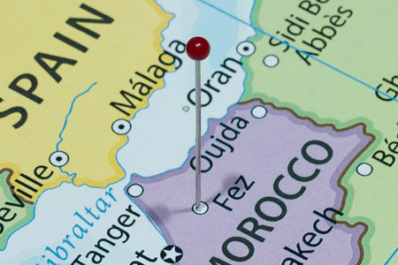 Close up to a Fez city with a red pin needle into Morocco country political mapの写真素材