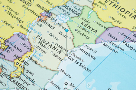 Close up to a Dar Es Salaam city with a light Blue pin needle into Tanzania country political map