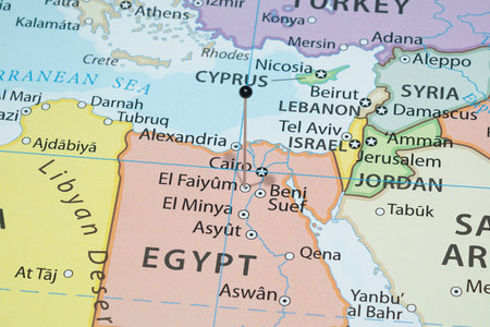 Close up to a El Faiyum city with a black pin needle into Egypt country political mapの写真素材