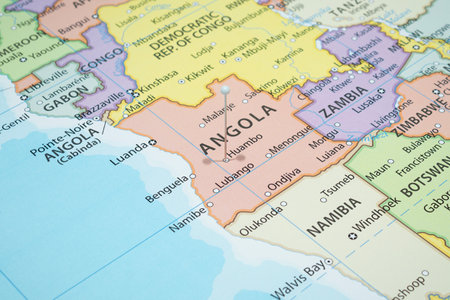 Close up to a Huambo city with a white pin needle into Angola country political mapの写真素材