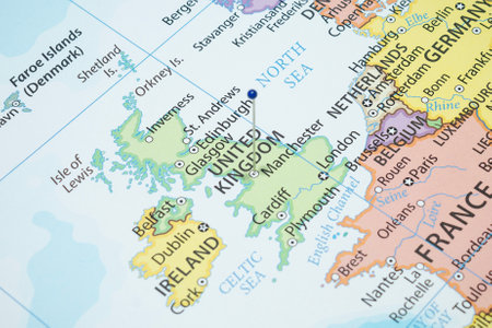 Close up to a Manchester city with a blue pin needle into England country political mapの写真素材