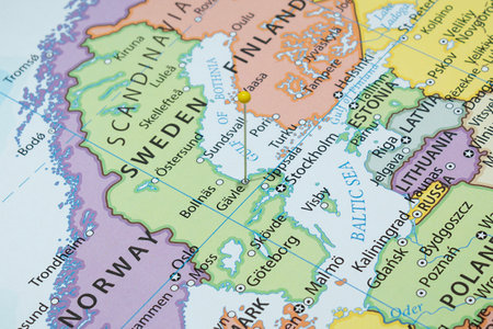 Close up to a Gavle city with a yellow pin needle into Sweden country political mapの写真素材