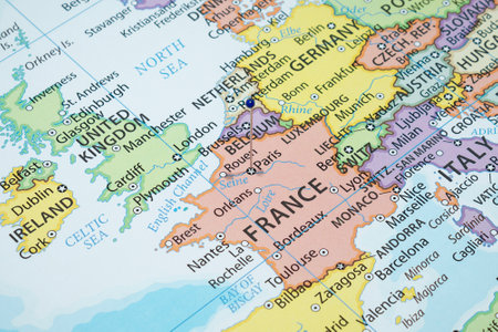 Close up to a Paris city with a blue pin needle into France country political mapの写真素材