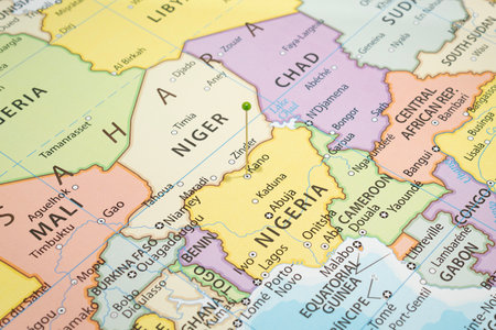 Close up to a Kano city with a green pin needle into Nigeria country political mapの写真素材