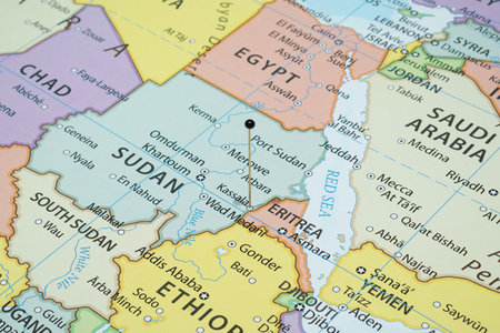 Close up to a Kassala city with a black pin needle into Sudan country political mapの写真素材