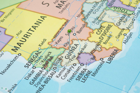 Close up to a Fria city with a green pin needle into Guinea country political mapの写真素材