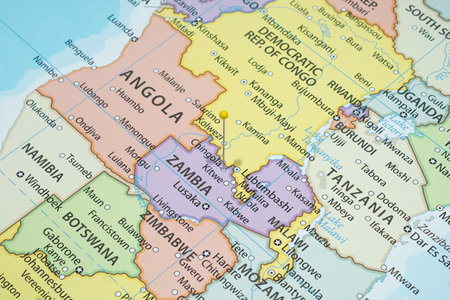 Close up to a Chingola city with a yellow pin needle into Zambia country political mapの写真素材