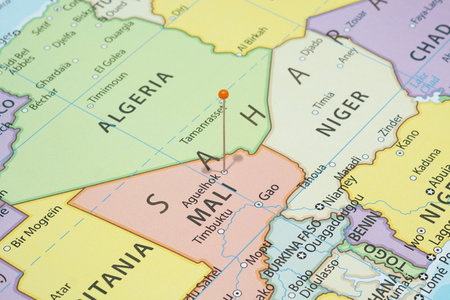 Close up to a Aguelhok city with an orange pin needle into Mali country political mapの写真素材