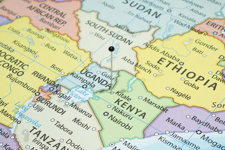 Close up to a Kitale with a black pin needle into Kenya country political mapの写真素材