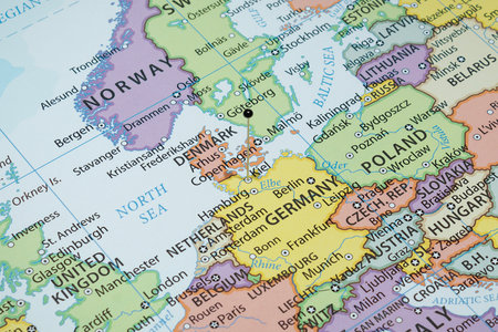 Close up to a Kiel city with a black pin needle into Germany country political mapの写真素材