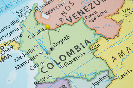 Close up to a Bogota city with a Yellow pin needle into Colombia country political mapの写真素材