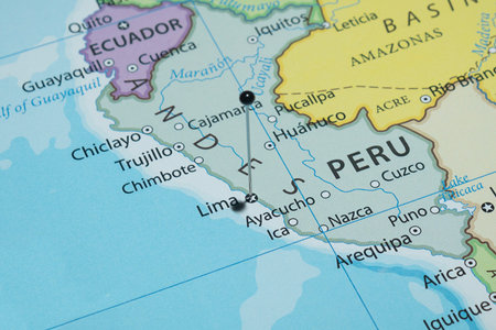 Macro photography of Lima city with a black pin needle into Peru country political map
