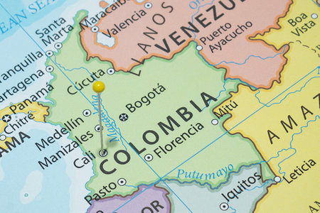 Close up to a Cali city with a Yellow pin needle into Colombia country political mapの写真素材