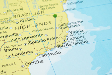 Close up to a Rio de Janeiro city with a green pin needle into Brazil country political mapの写真素材
