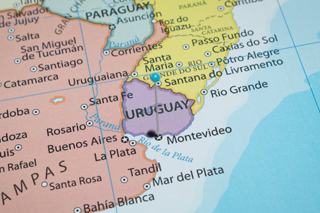 Macro photo of Montevideo city with a light blue pin needle into Uruguay political country mapの写真素材