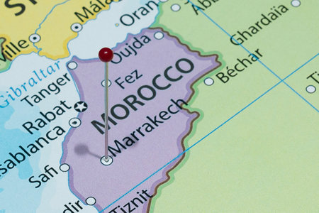 Close up to a Marrakesh city with a red pin needle into Morocco country political mapの写真素材
