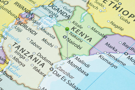 Close up to a Mombasa city with a green pin needle into Kenya country political mapの写真素材