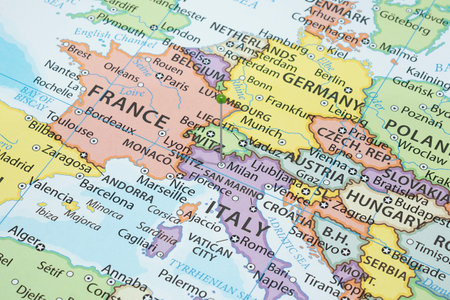 Close up to a Milan city with a green pin needle into Italy country political mapの写真素材