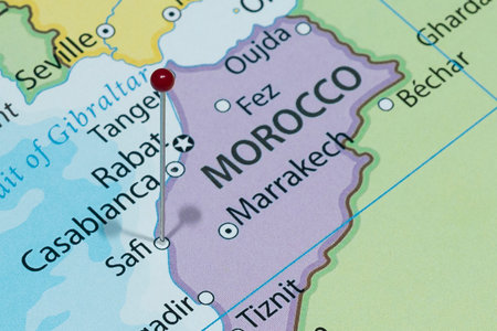 Close up to a Safi city with a red pin needle into Morocco country political map