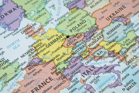 Close up to a Munich city with a black pin needle into Germany country political map