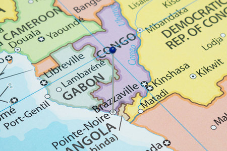 Close up to a Pointe Noire city with a blue pin needle into Congo country political mapの写真素材