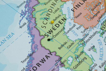 Close up to a Ostersund city with a yellow pin needle into Sweden country political map