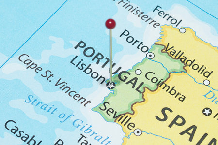 Close up to a Lisbon city with a red pin needle into Portugal country political map