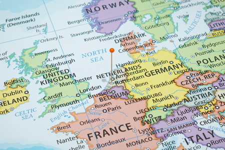 Close up to a Rotterdam city with an orange pin needle into Netherlands country political mapの写真素材