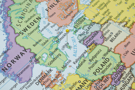 Close up to a Visby city with a yellow pin needle into Sweden country political map