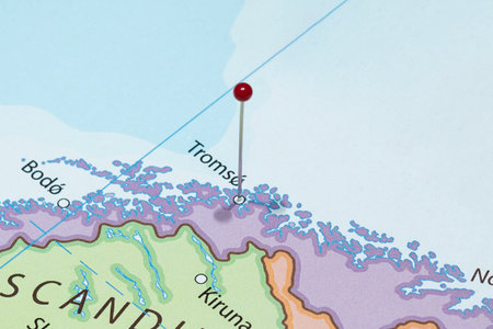 Close up to a Tromso city with a red pin needle into Norway country political map