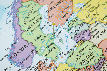 Close up to a Stockholm city with a yellow pin needle into Sweden country political map