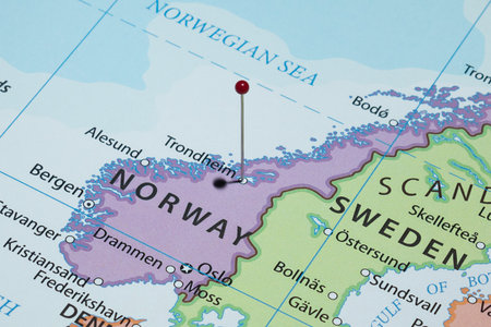 Close up to a Trondheim city with a red pin needle into Norway country political map
