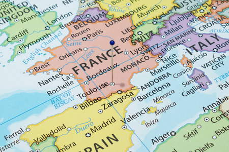 Close up to a Toulouse city with a blue pin needle into France country political mapの写真素材