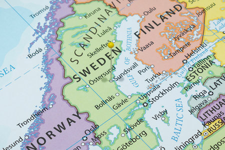 Close up to a Sundsvall city with a yellow pin needle into Sweden country political map
