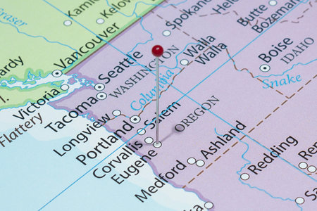 Close up to a Eugene city with a red pin needle into United States of America country political mapの写真素材
