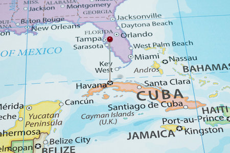 Macro photography of Havana city with a red pin needle into Cuba country political mapの写真素材