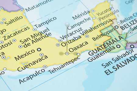 Close up to a Oaxaca city with a white pin needle into Mexico country political map