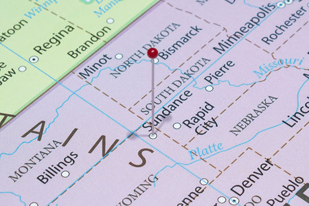 Close up to a Sundance city with a red pin needle into United States of America country political mapの写真素材