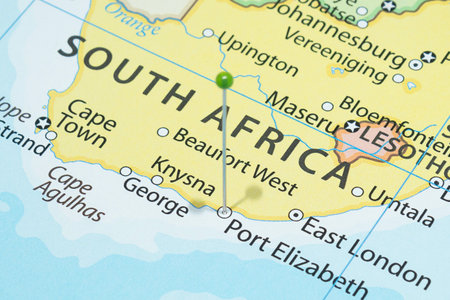 Close up to a Port Elizabeth city with a green pin needle into South Africa country political map