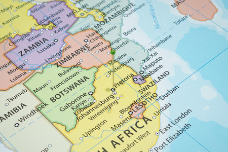 Close up to a Pretoria city with a green pin needle into South Africa country political mapの写真素材